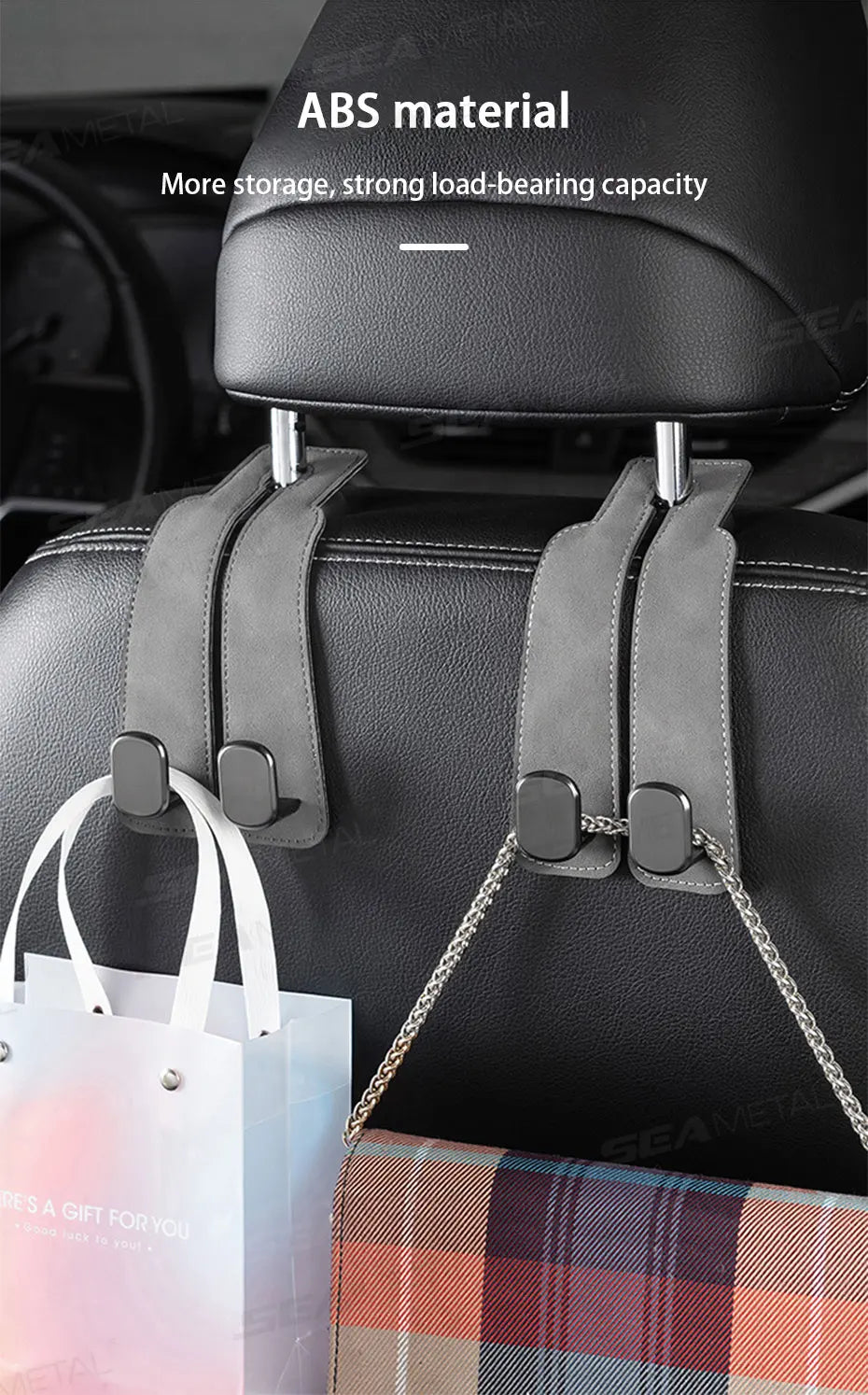 A black car seat back with an ABS material storage hook and leather strap, next to a white shopping bag and plaid fabric.