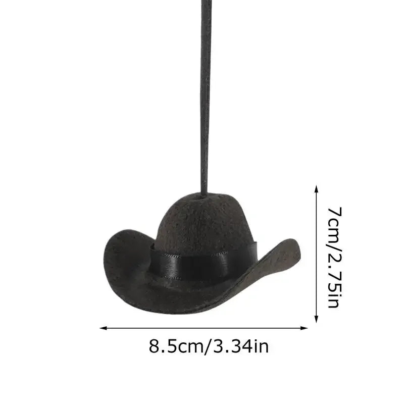 Black fabric cowboy hat ornament hanging from a string