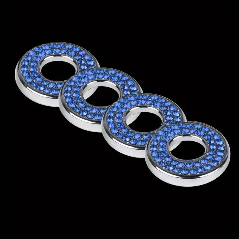 A set of elegant car door lock pin trim featuring round, blue-studded metal rings.