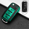 A green TPU car key fob cover with multiple buttons is shown on a black textured surface, next to an inset showing the key fe