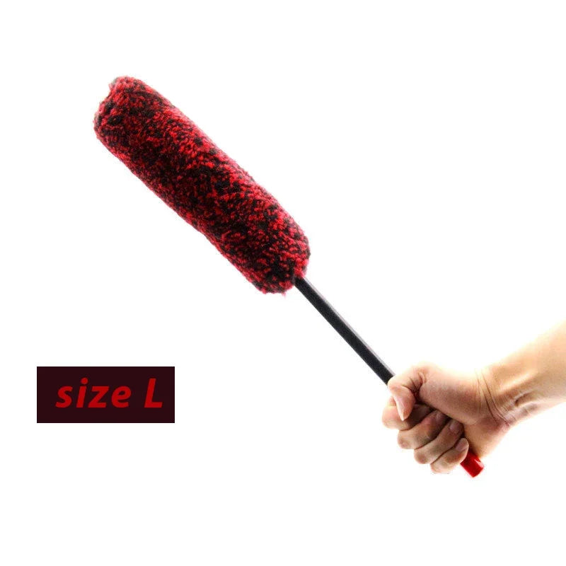 A hand holds a red wool cleaning brush with a black handle, labeled size L.