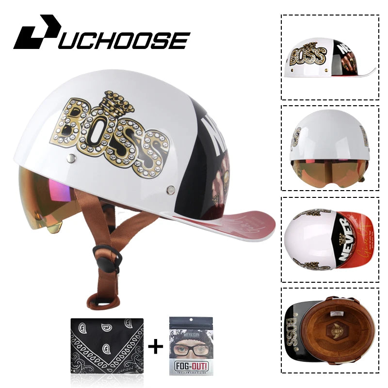 A white motorcycle helmet with a gold Boss logo and a black visor, shown alongside accessories.