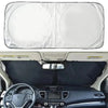 A white car windshield sun shade visor protector is shown open in the vehicle interior.