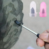 A hand applies a rubber plug from a compact tire repair kit onto a tire tread.