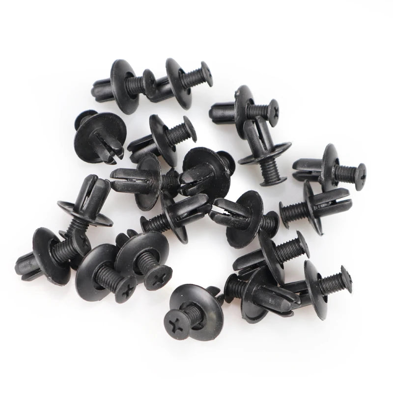 A collection of black plastic fasteners used for vehicle trim.