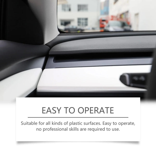 A close-up of a car interior showing a plastic surface being treated with a restorer spray.