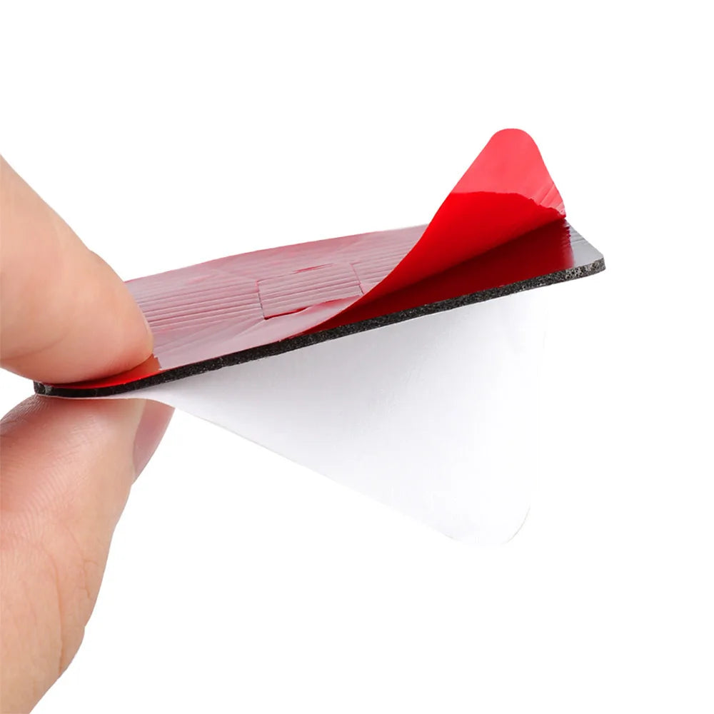 A hand holds a red plastic light projector with a Citroën logo design against a white background.