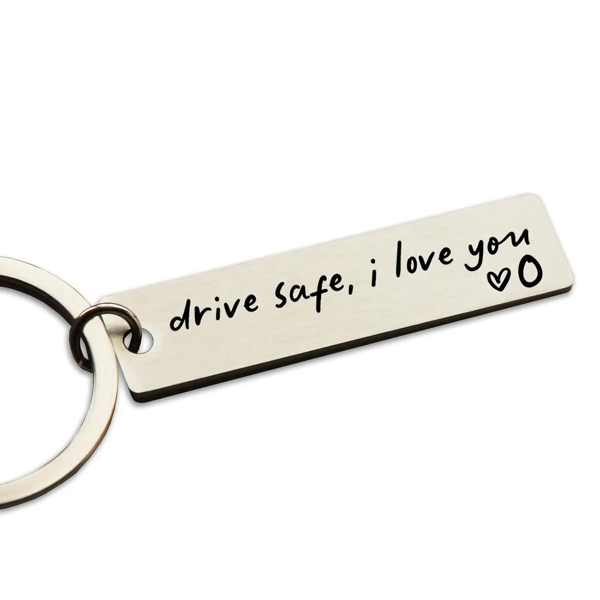 A stainless steel keychain tag engraved with the message drive safe i love you and a heart symbol