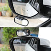 A close-up view of a black blind spot mirror mounted on a car door, showing the interior and exterior reflection.