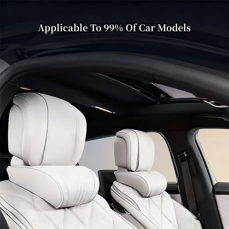 White ergonomic lumbar and neck pillow placed on a black car seat interior.