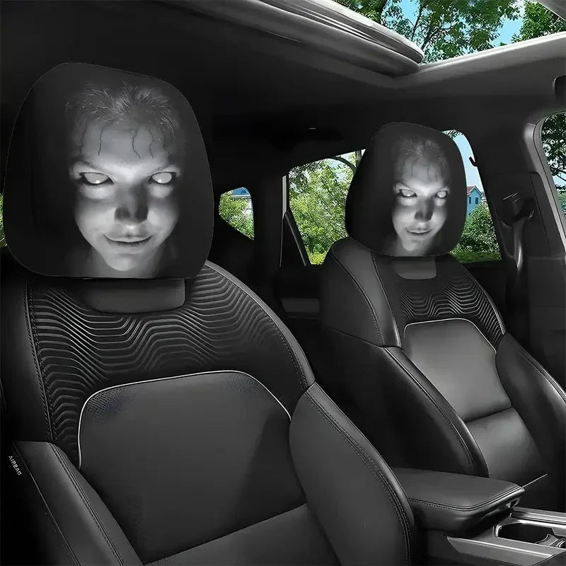 Two black universal car headrest covers installed in a vehicle seat.