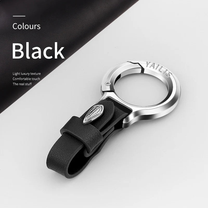 A black YALIS branded metal key ring attached to a black leather strap, shown on a white background.
