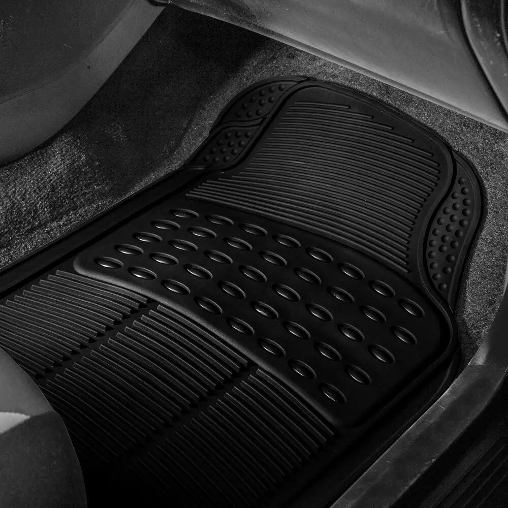 Close-up view of a black heavy-duty rubber floor mat with textured patterns inside a vehicle