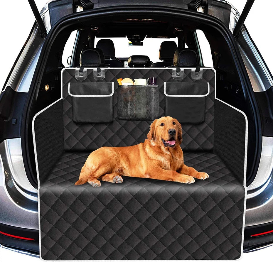 A golden retriever is resting on a black waterproof pet trunk liner inside a car.