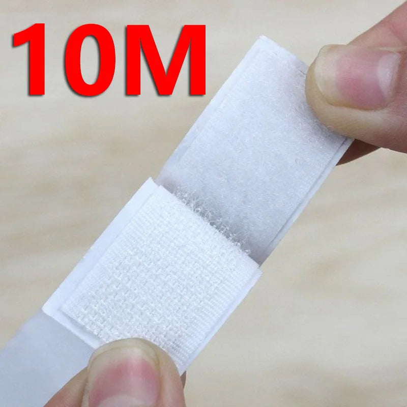 A hand is holding a white self-adhesive hook and loop tape strip, showing its texture and thickness.