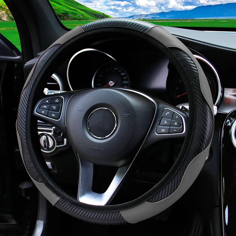 A black steering wheel with a PU carbon fiber cover is visible inside a car cabin.