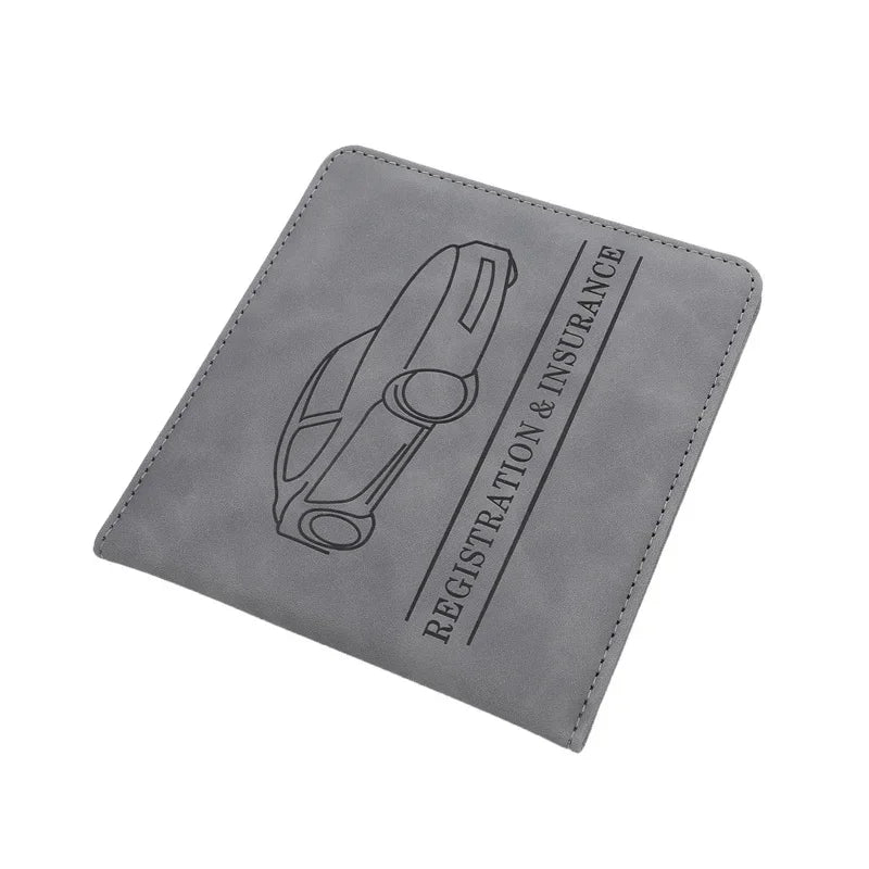 A gray leather document holder featuring a line drawing of a car and the text REGISTRATION & INSURANCE.