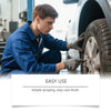A man in a blue shirt is applying a multi-purpose rust remover spray cleaner to a car wheel.