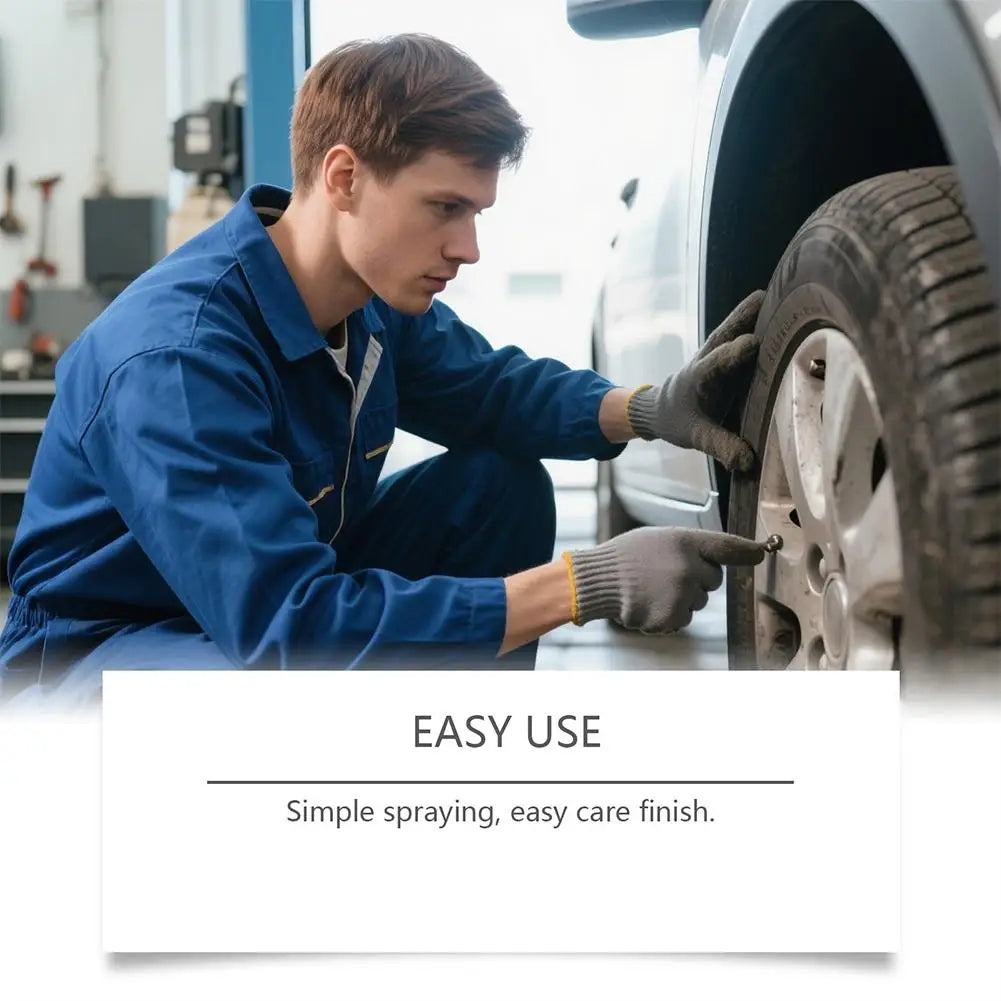 A man in a blue shirt is applying a multi-purpose rust remover spray cleaner to a car wheel.