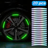 A close-up of a car wheel with bright green LED accents and a strip of iridescent light.