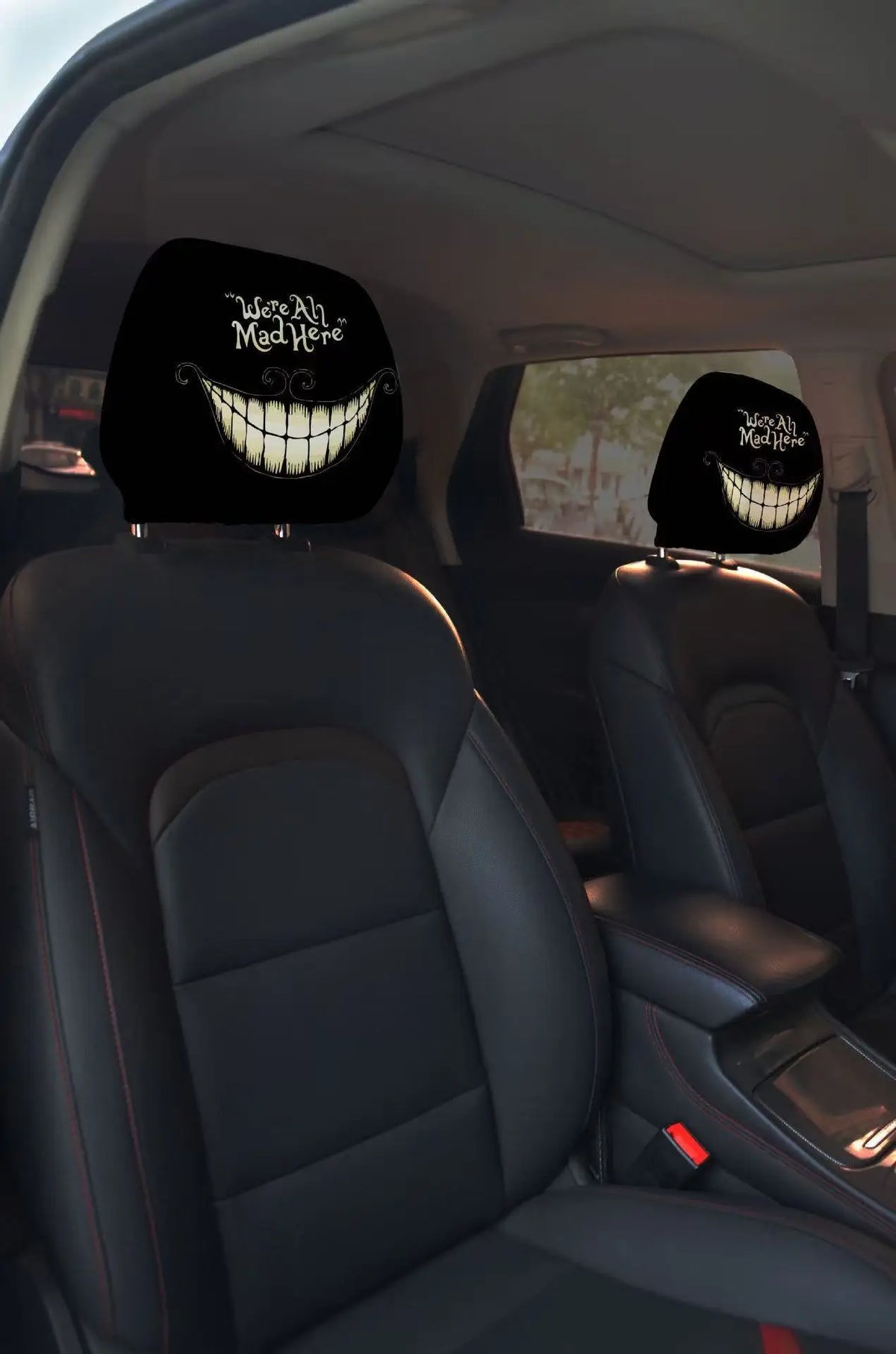Black car headrest covers featuring a grinning skull design with the text Where Ah Mad Here