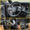 Close-up view of a black steering wheel trim cover installed on a vehicle's steering wheel.