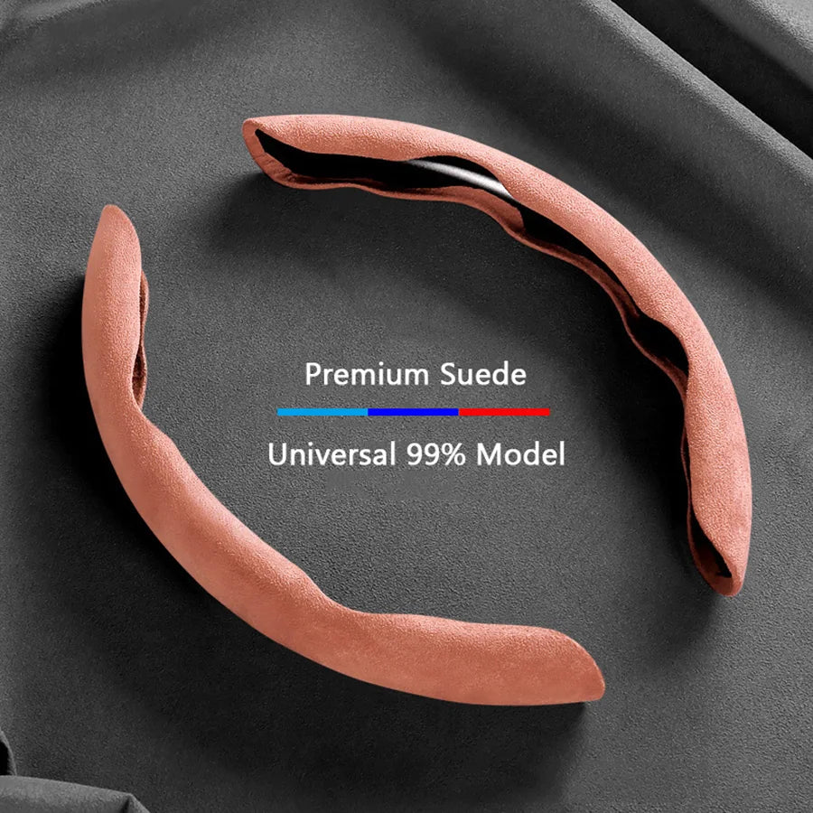 A curved suede steering wheel cover in a dusty rose color shown against a dark background.