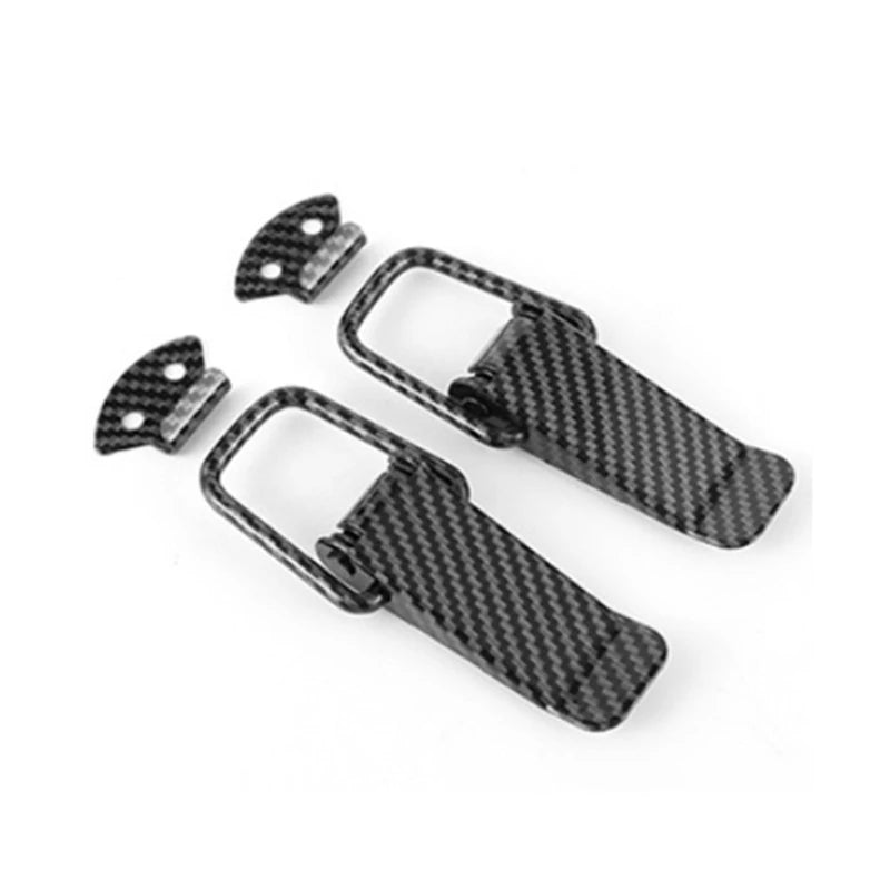 Two black carbon fiber pull buckle repair clips for car trunk.
