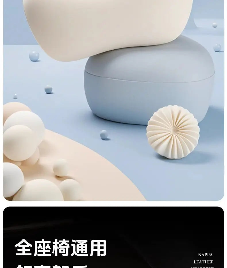 A light blue car neck pillow is shown resting on a soft, beige surface with other white pillows.