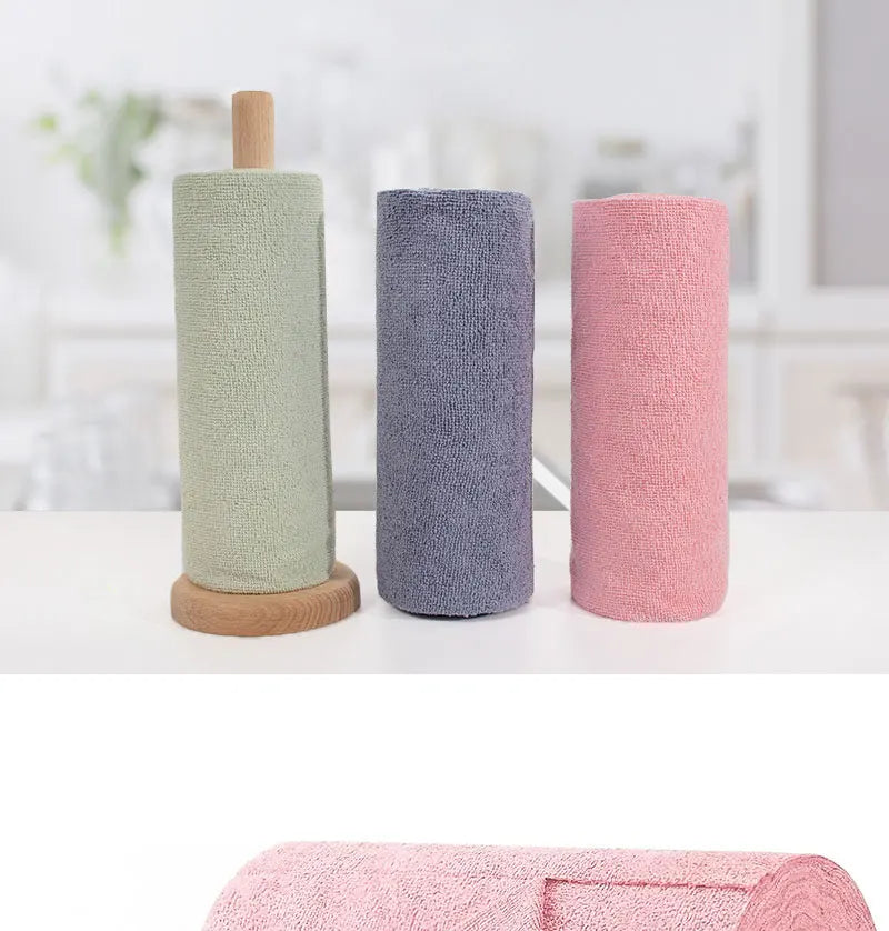 Three cylindrical reusable microfiber cleaning towels in light green, gray, and pink.