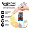 A hand holds a pink fruit air freshener next to citrus slices and pine cones, demonstrating the renewed scent experience.