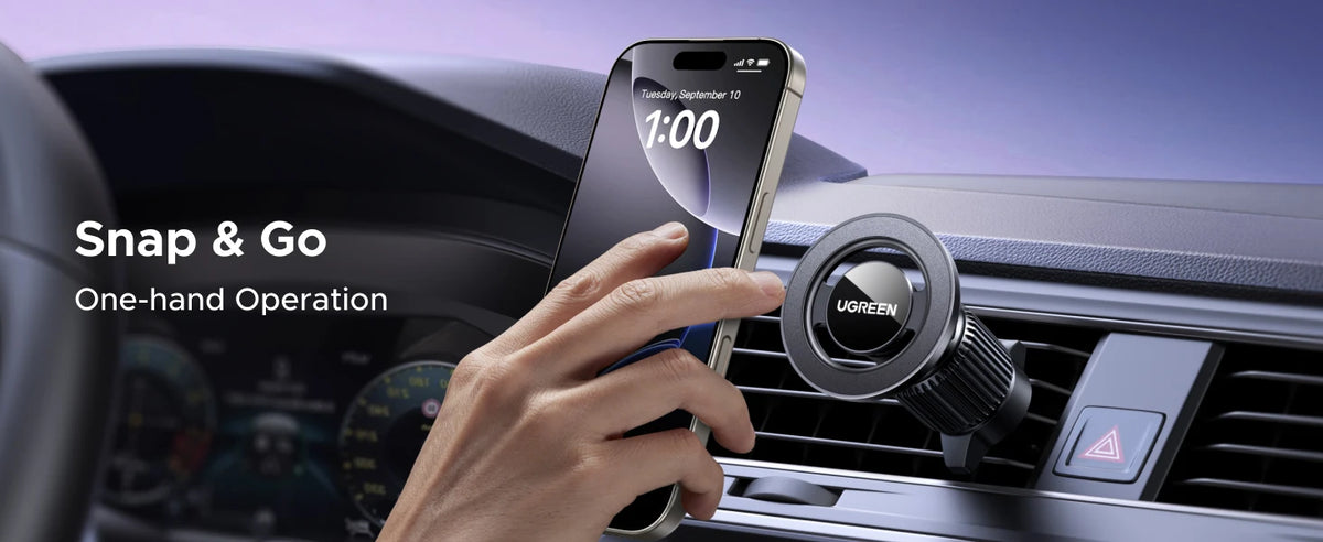 A hand uses a magnetic car phone holder to operate a smartphone displaying the time.
