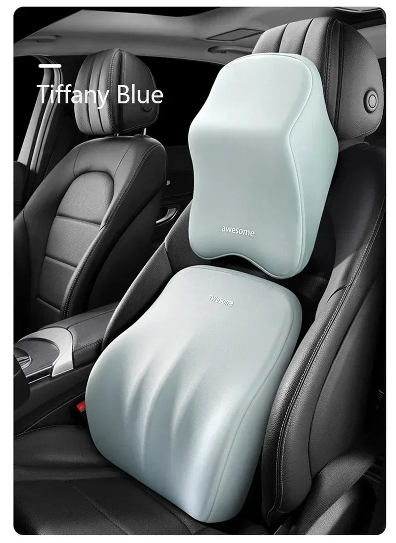 A light blue ergonomic lumbar and neck support cushion placed on a black car seat.