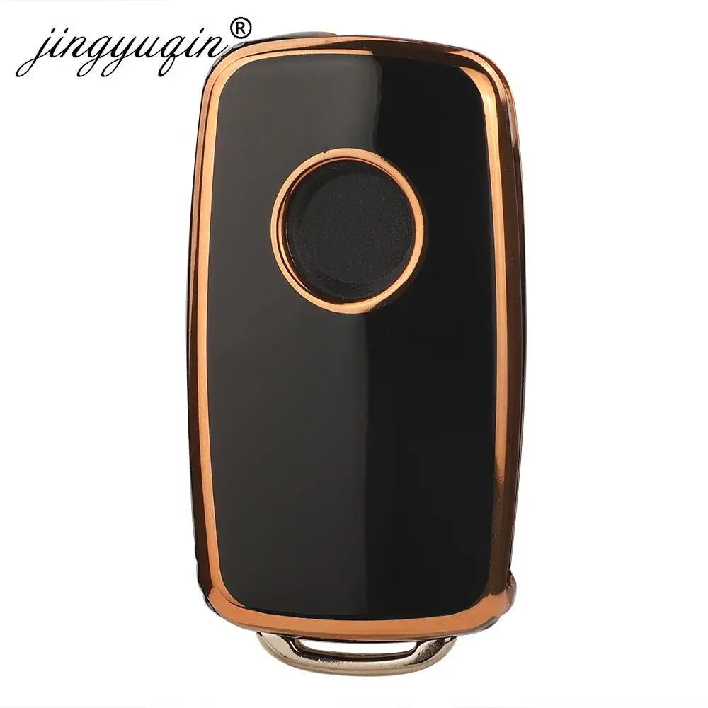 A black silicone TPU car key cover protector with a round metallic accent.