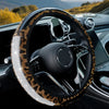 A close-up view of a black steering wheel with a leopard print cover and rhinestone accents inside a car interior.