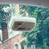A clear EZ Pass holder is visible on a windshield, showing suction cups and a barcode.