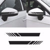 Close-up view of a white car side mirror with a black racing stripe decal applied to the housing.