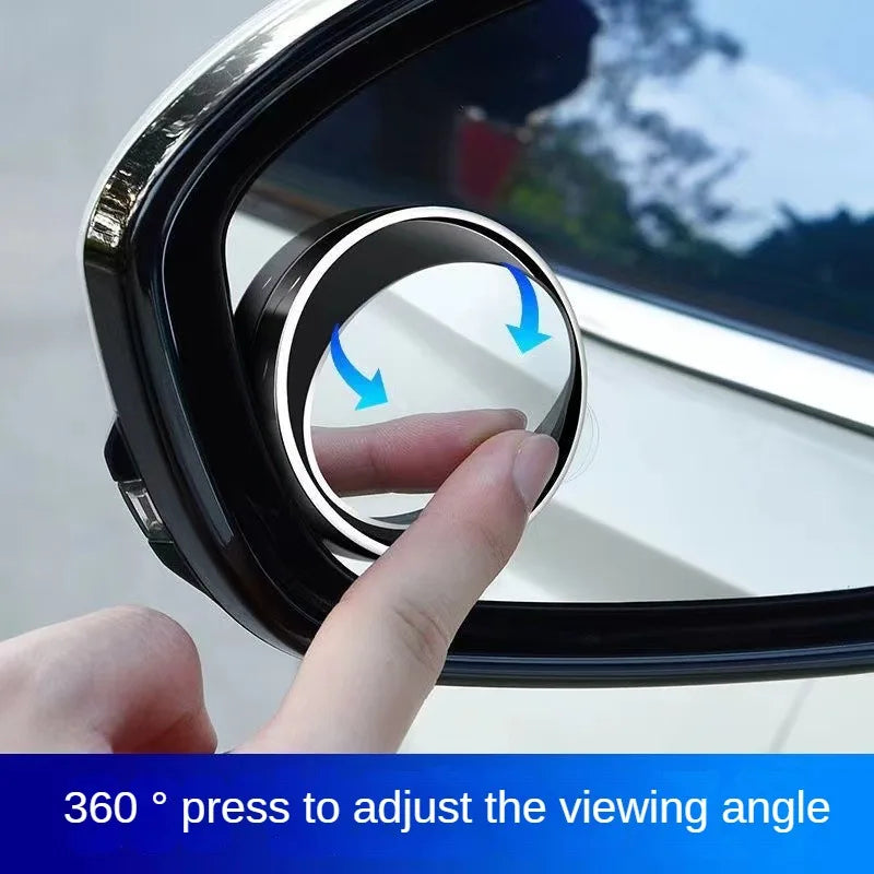 A hand adjusts the viewing angle of a 360 degree suction cup rearview mirror.