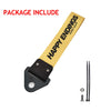 A yellow tag with HAPPY ENDINGS printed on it, along with a black metal fitting and a small bolt.