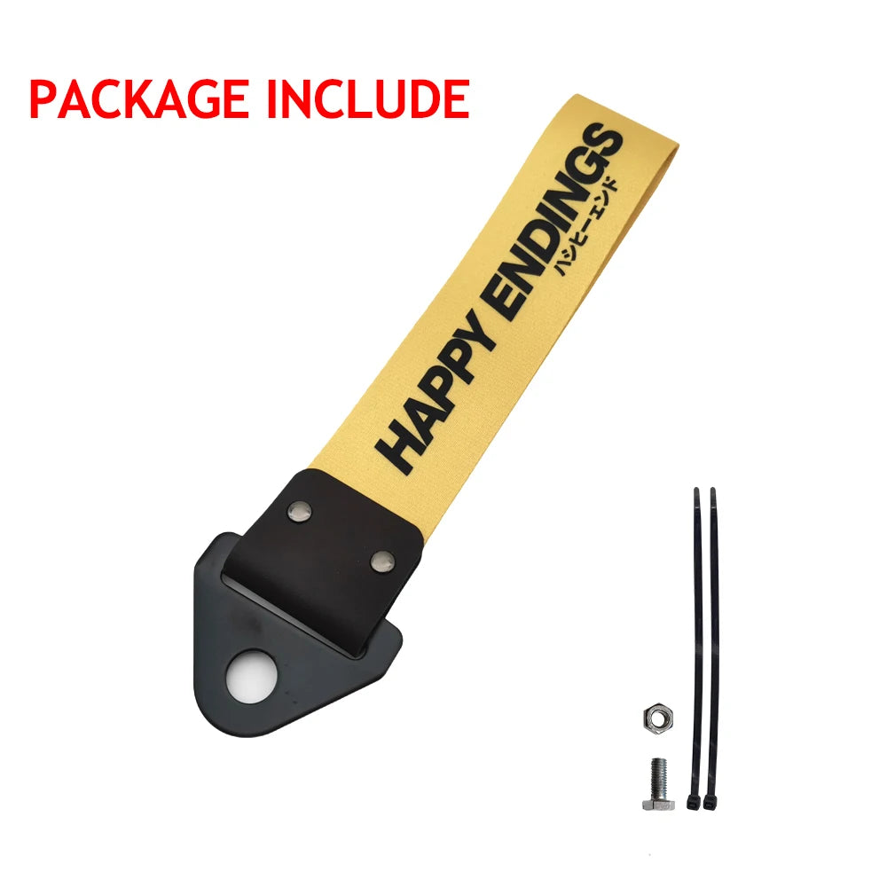 A yellow tag with HAPPY ENDINGS printed on it, along with a black metal fitting and a small bolt.