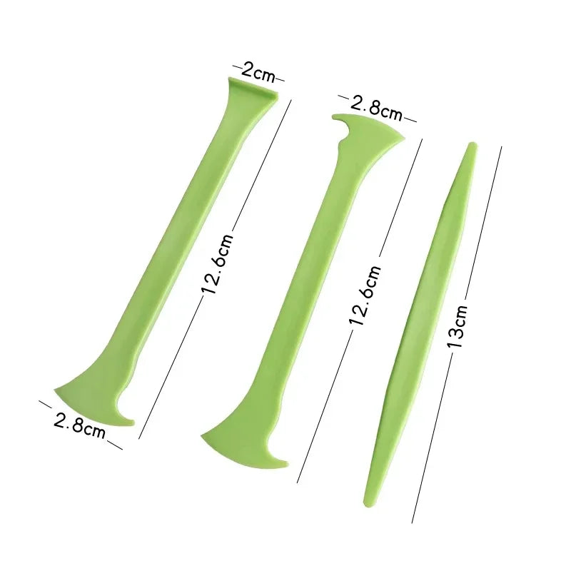 A set of green vinyl car wrap tools showing various lengths and shapes for application.