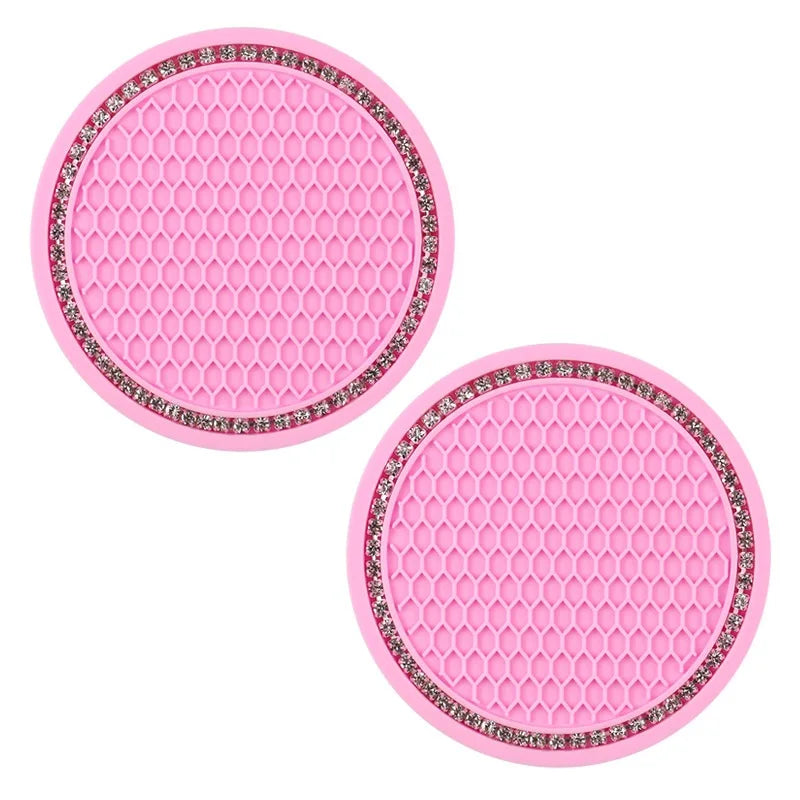 A set of pink decorative rhinestone car coasters with a hexagonal pattern.