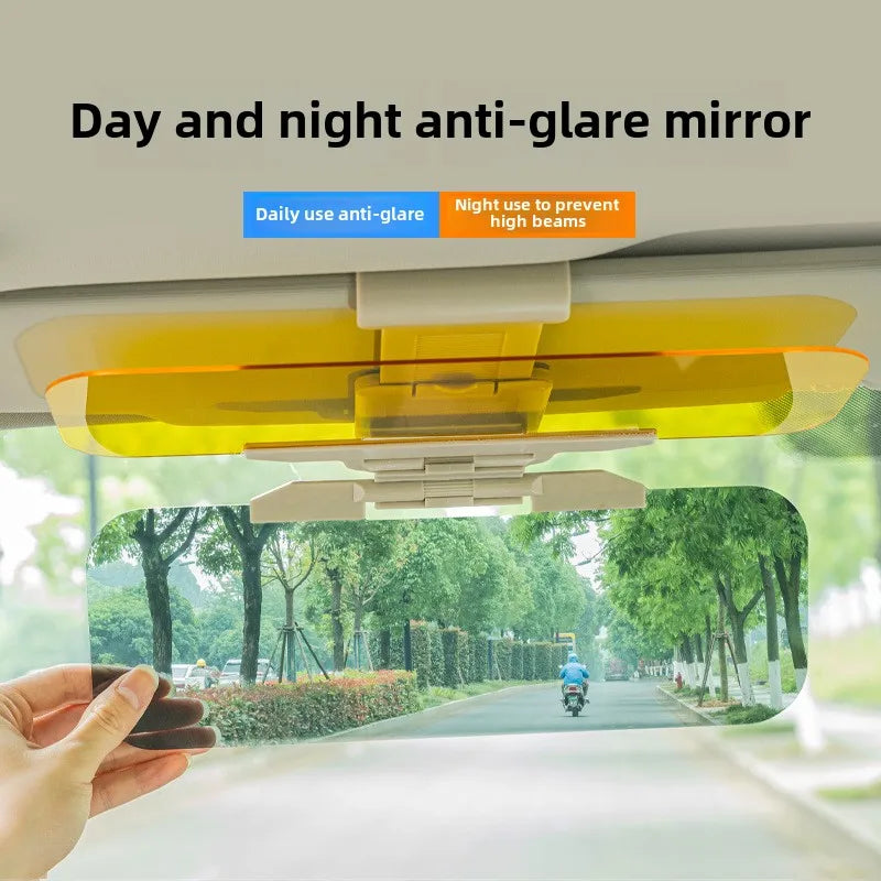 A hand holds an HD anti-glare car sun visor with dual-purpose vision lenses, showing a clear view of a road and trees.