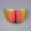 A curved, iridescent anti-fog visor for a motorcycle helmet, displaying a gradient of orange and green colors.
