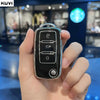 A hand holds a black TPU car key cover for Volkswagen, Skoda, and Seat vehicles.