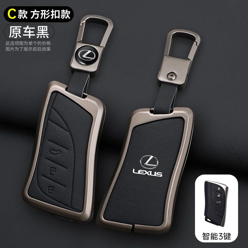 A black leather car key cover shell with a metallic finish shown next to a smart phone.
