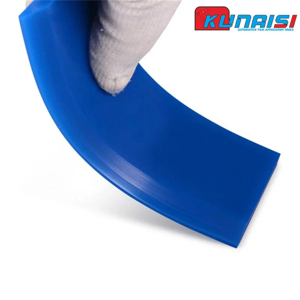 A blue silicone scraper tool is shown being used to remove film or glass, held by a hand.
