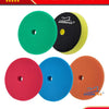 A set of four professional car care polishing sponge pads in green, black, red, and blue.
