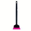 A black car window film installation tool with a pink rubber blade.