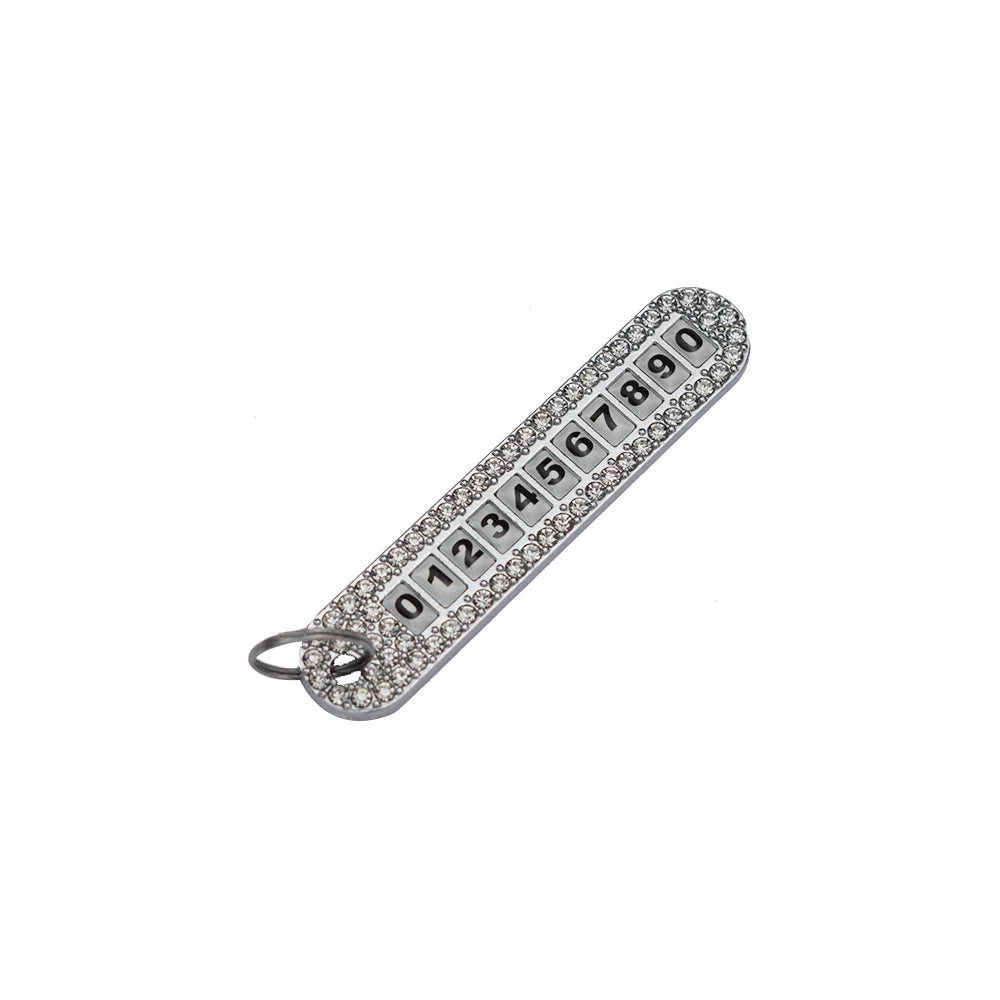Silver diamond-encrusted key case cover with numbers 01234567890